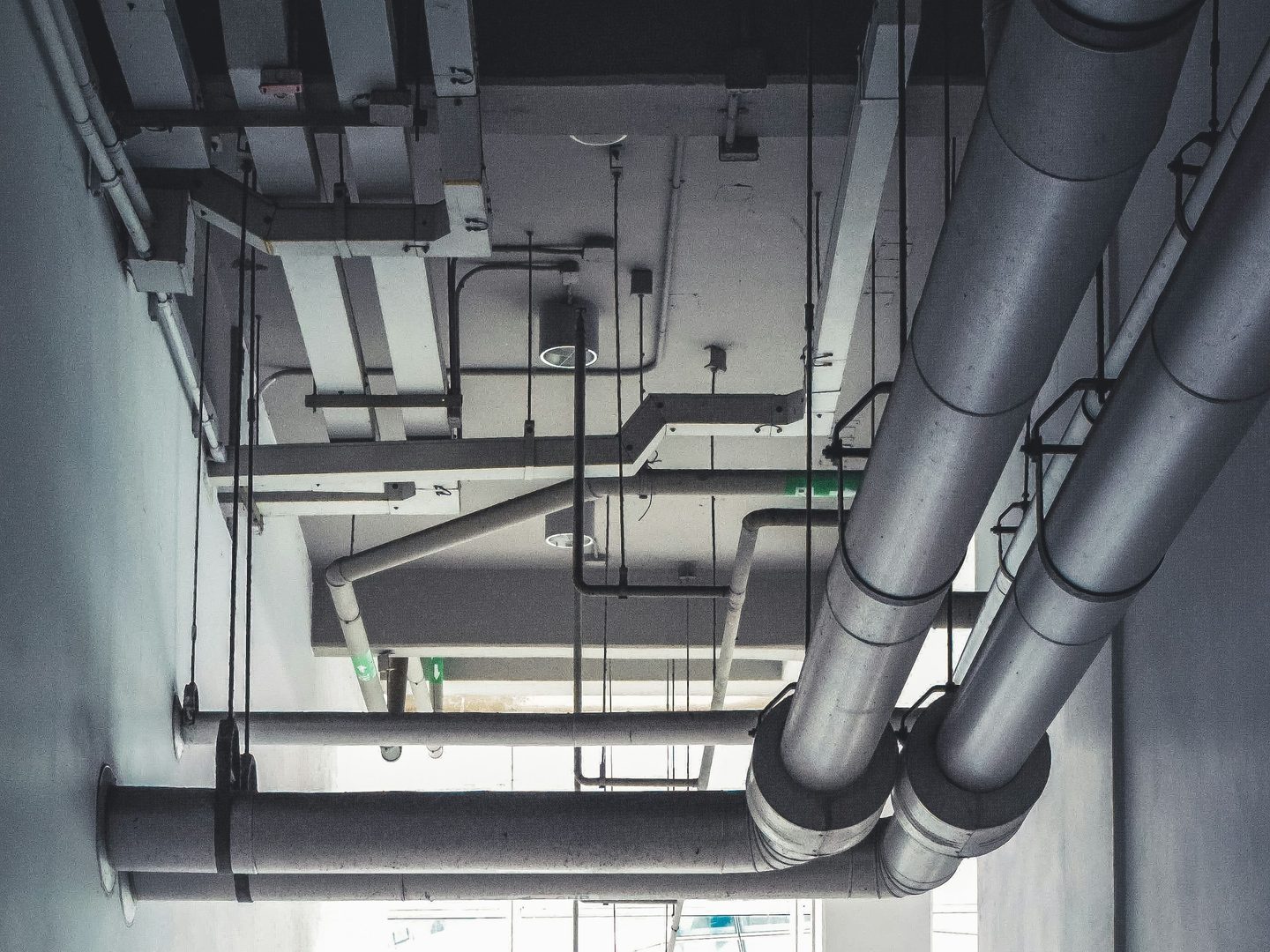Ductwork and pipework under a building ceiling