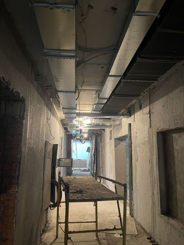 Ducts under the slab and a scaffold for installation